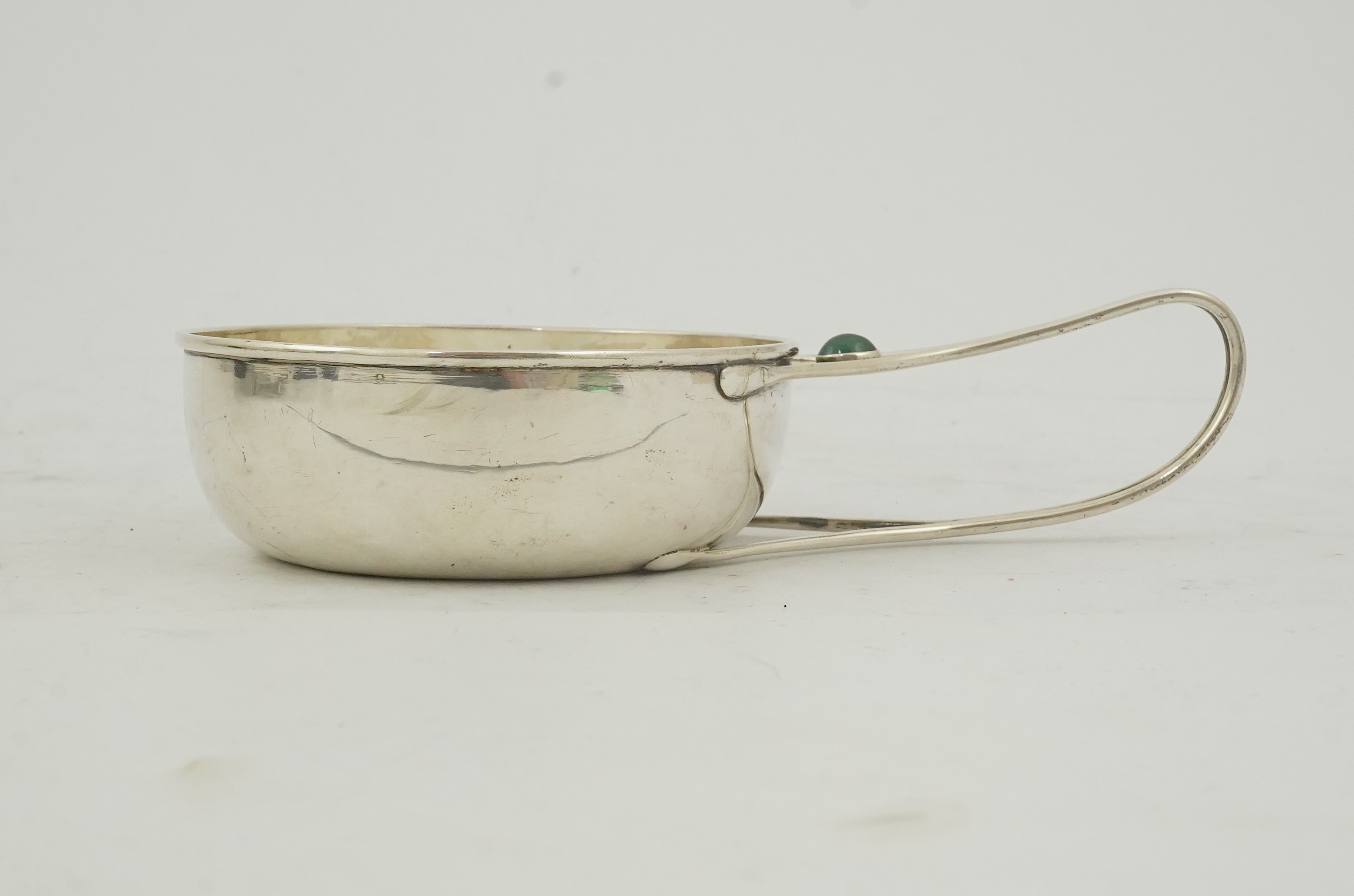 An Edwardian Arts & Crafts Charles Robert Ashbee for the Guild of Handicrafts Ltd silver and single stone cabochon chrysoprase set porringer